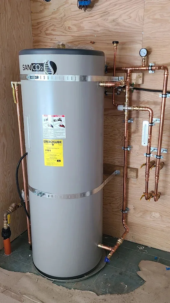 Water heater with new copper supply piping, shut-off valves, and a pressure gauge